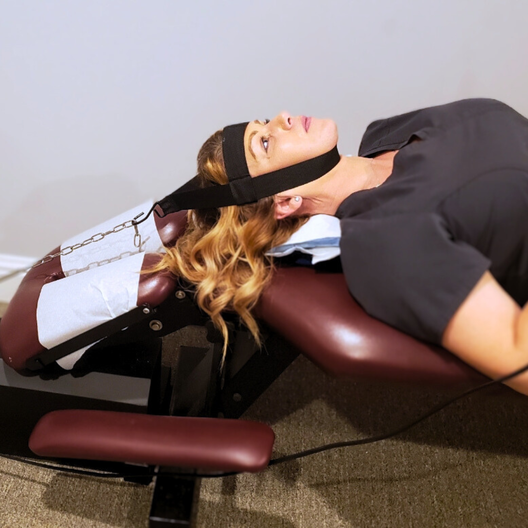 Image of patient receiving treatment from mi-trac cervical traction device in chiropractic practice in loganville, georgia